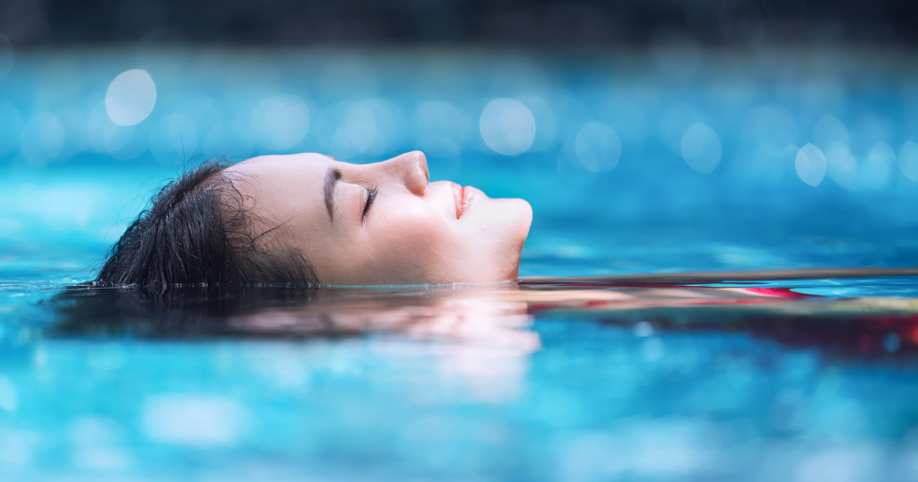 Woman relaxing in a pool