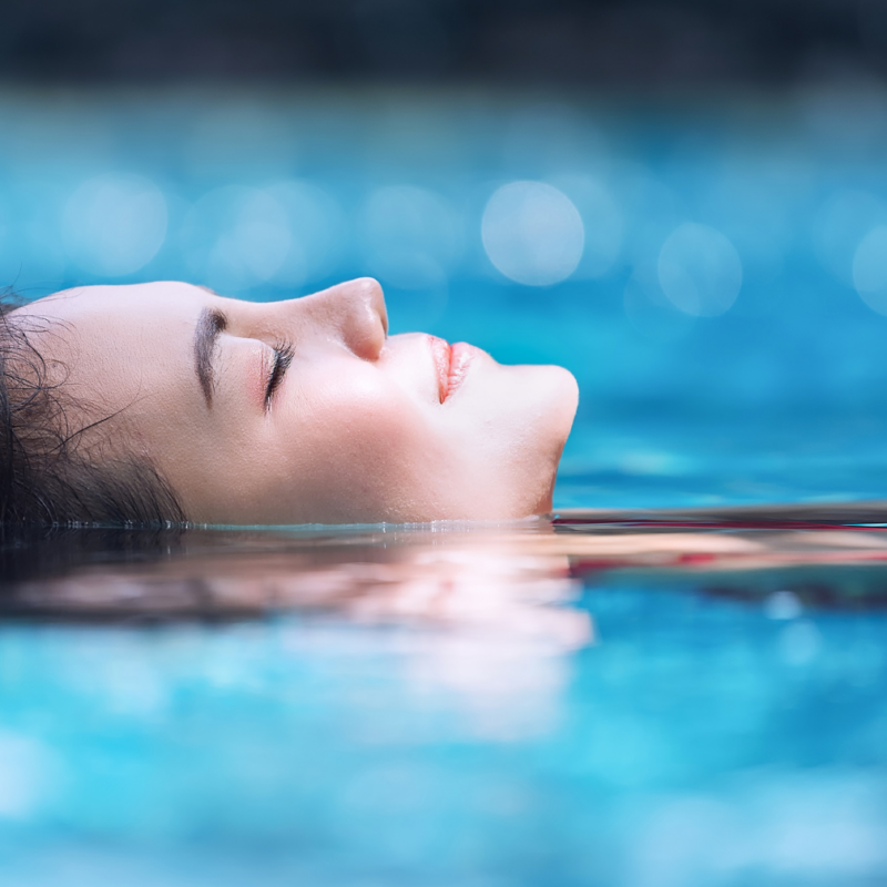 Woman relaxing in a pool